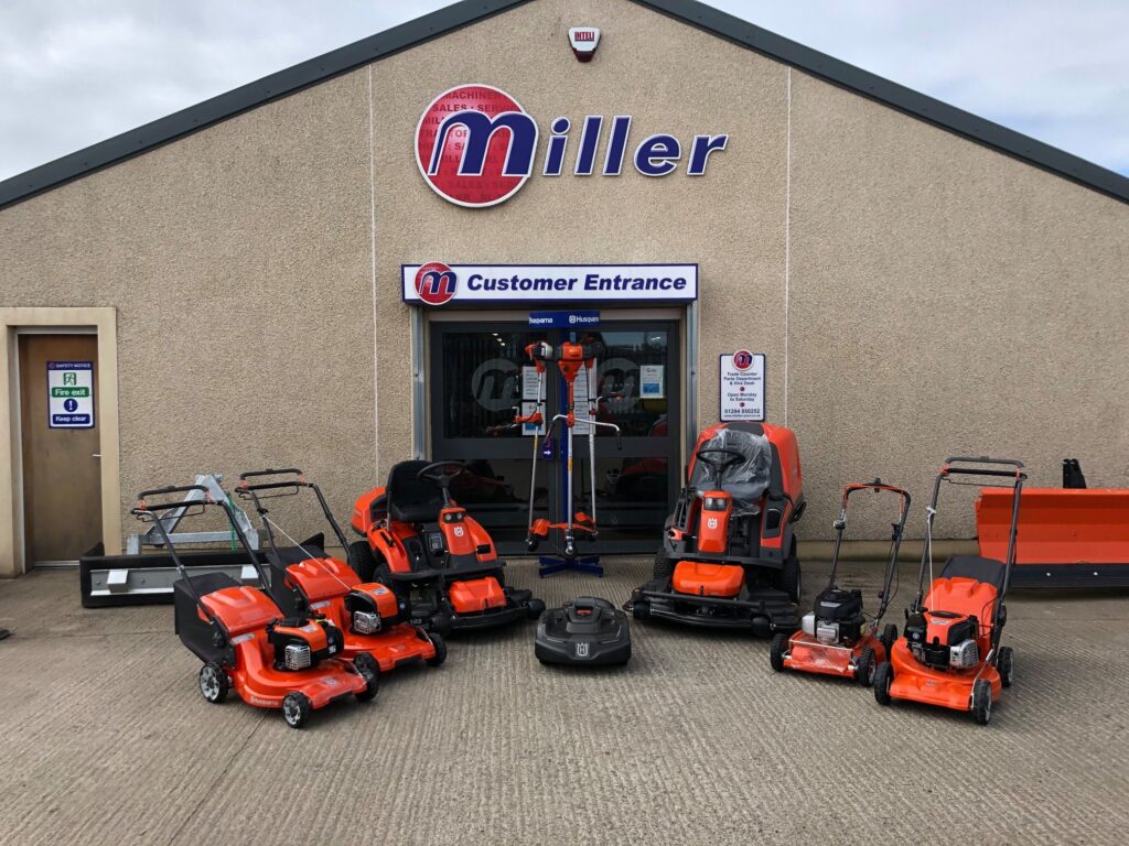 Wide range of Husqvarna lawnmowers displayed outside R&L Miller shop in Ayrshire, available for sale.
