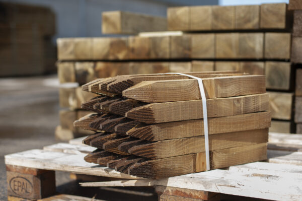 Bundle of pointed timber site pegs on pallet, used for setting out construction or landscaping projects