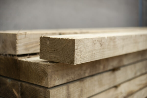 Close-up of stacked treated timber sleepers showing smooth edges and clean cuts