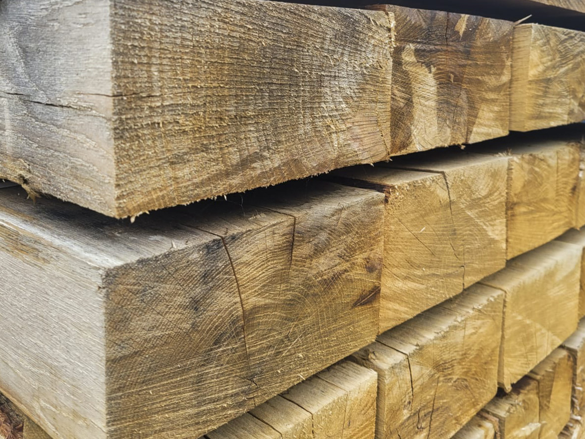 Stacked oak sleepers supplied by R&L Miller in Ayrshire for landscaping and farm construction