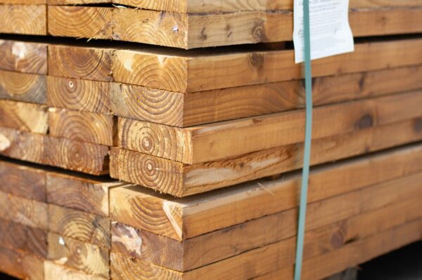 Pallet of pressure-treated timber joists for decking, fencing, and structural outdoor projects