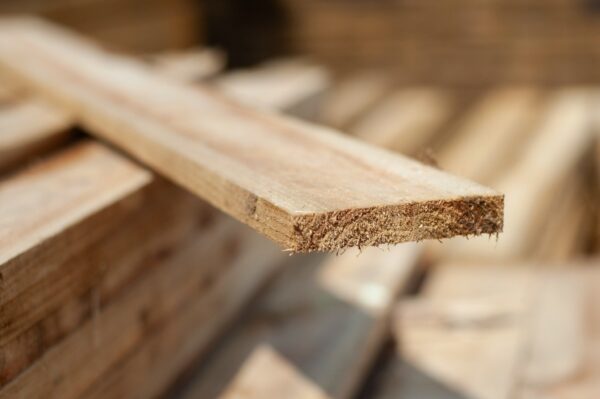 Close-up of timber fence slat with soft focus stack, used for garden fencing and timber projects