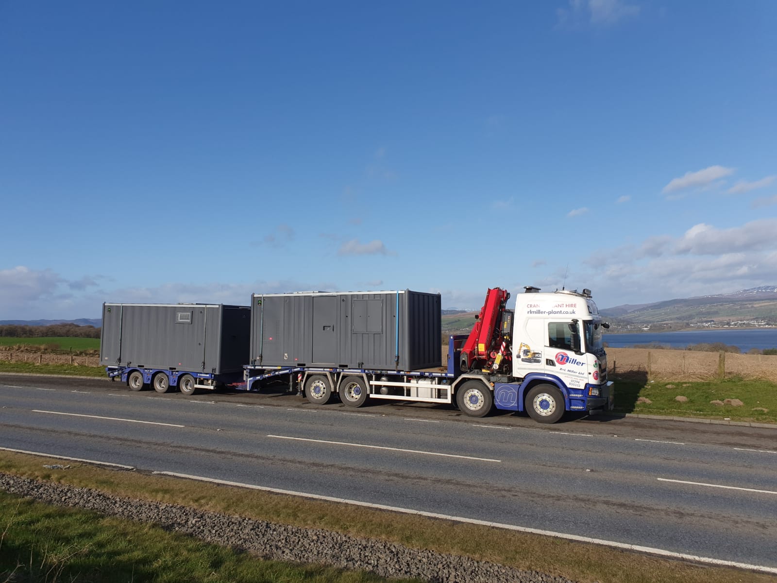 Shipping container being transported by a HIAB vehicle